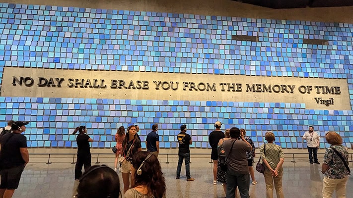 An art installation made up of thousands of blue tiles and the quote, "No day shall erase you from the memory of time" by Virgil.